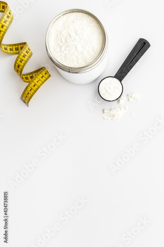 Whey prorein in jar with tape measure. Sport nutrition. Overhead view