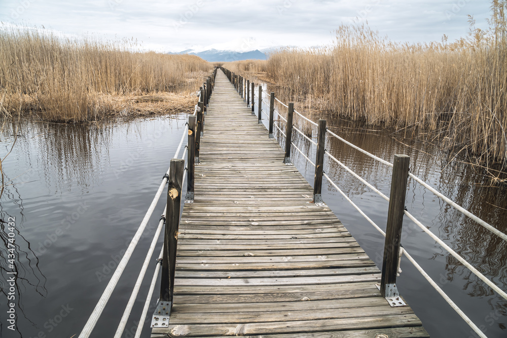 A wooden footbridge leading through marshes and lakes inside the Central Anatolian Sultan Reedy (Sultansazligi) National Park, Turkey