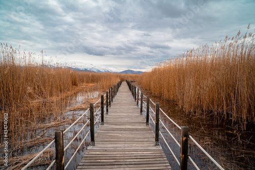 Wooden bridge leading through marshes and lakes inside the Central Anatolian Sultan Reedy (Sultansazligi) National Park, Turkey