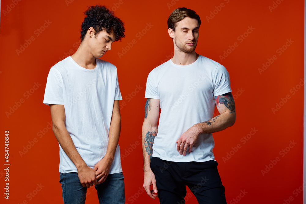 two man in white t-shirts communication friendship red background two man in white t-shirts communication friendship red background