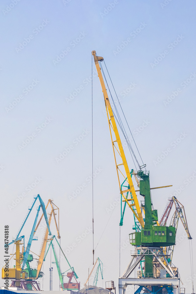 Working port cranes. Unloading and loading of goods at the port. Working port cranes. Unloading and loading of goods at the port.
