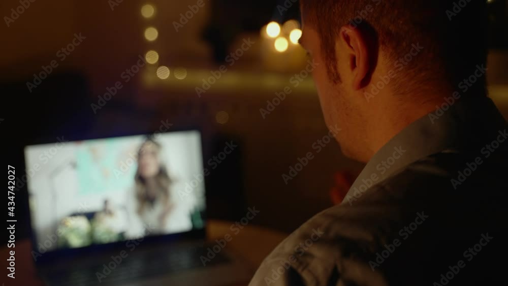 Man talking with his family in video chat at night. Time differences between time zones. Man talking with his family in video chat at night. Time differences between time zones.