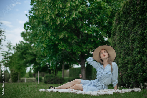 Romantic girl with hat on picnic in park