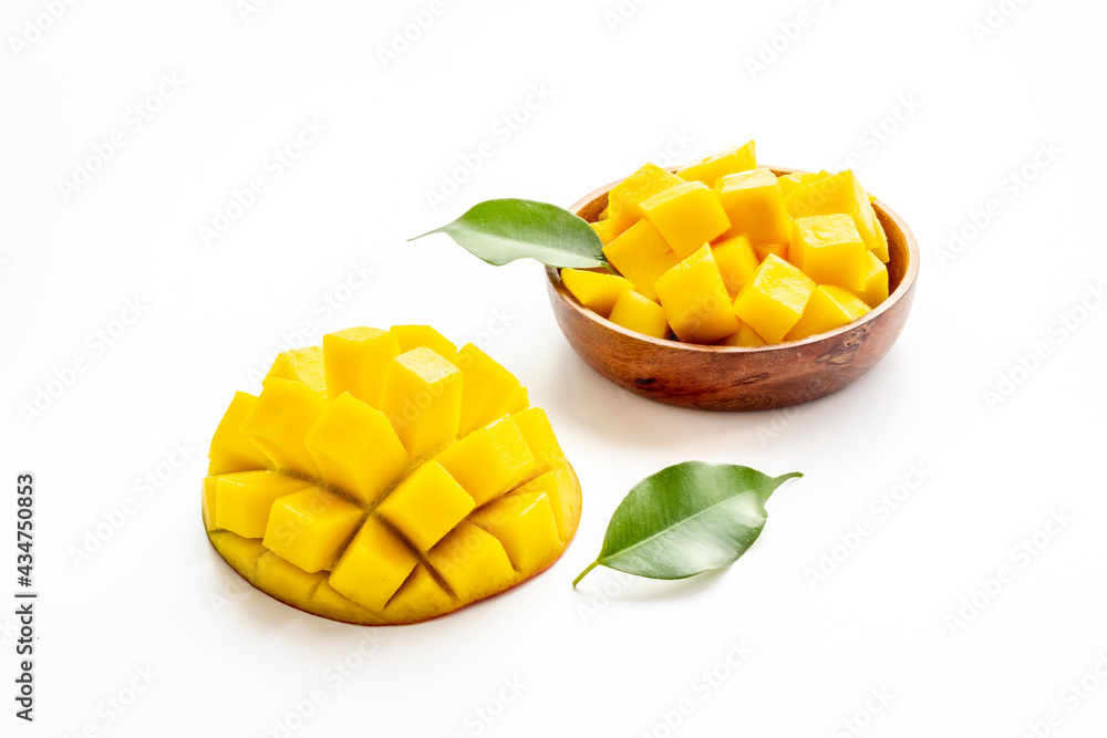 Tropical mango slices and cubes in wooden bowl