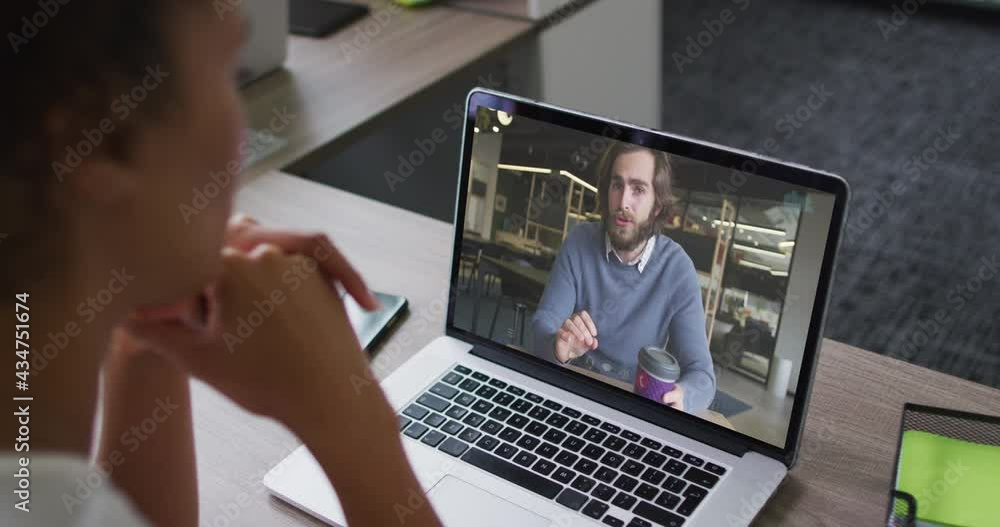 African american woman having a video call on laptop with male colleague at office African american woman having a video call on laptop with male colleague at office