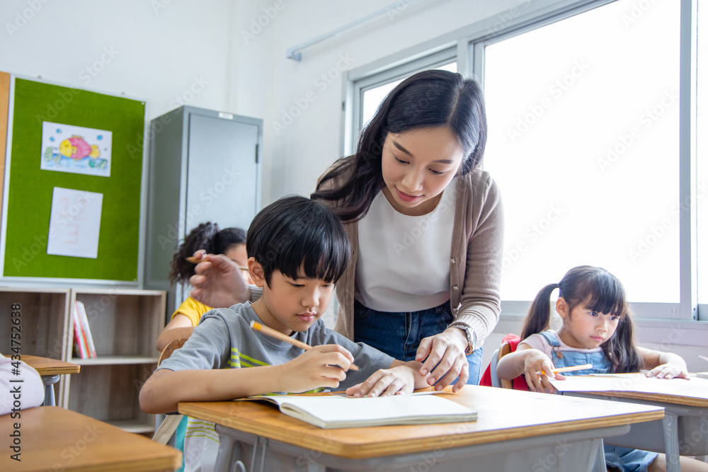 Diversity elementary school kid Take note Teacher lecture in classroom Diversity elementary school kid Take note Teacher lecture in classroom