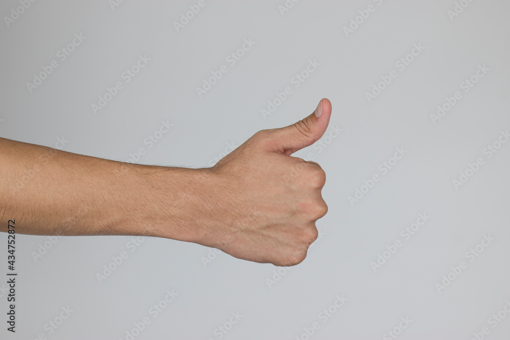 The hand of a man who thumbs up to show the sign of appreciation, Like, Excellent, Encourage. (Clipping Path) The hand of a man who thumbs up to show the sign of appreciation, Like, Excellent, Encourage. (Clipping Path)