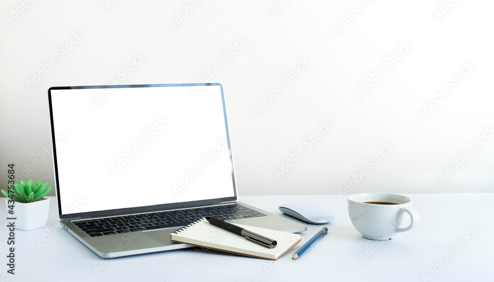 Laptop computer blank screen on white office desk table with coffee cup and notebook, mouse computer with equipment office supplies. Business and finance concept. Workplace, Flat lay with copy space. Laptop computer blank screen on white office desk table with coffee cup and notebook, mouse computer with equipment office supplies. Business and finance concept. Workplace, Flat lay with copy space.
