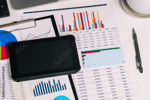 Workplace with a tablet, documents and graphs. Planning income and expenses. Tax calculation and budget planning