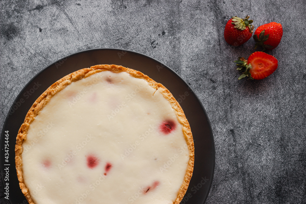 Delicious pie with strawberries and cream. Pie on the table. Pie with berries on a plate Delicious pie with strawberries and cream. Pie on the table. Pie with berries on a plate