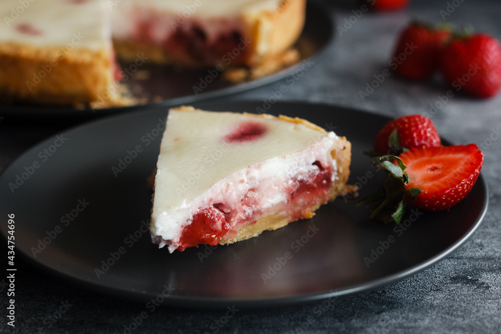 Delicious pie with strawberries and cream. Pie on the table. Pie with berries on a plate Delicious pie with strawberries and cream. Pie on the table. Pie with berries on a plate