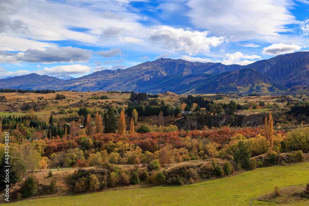 Autumn landscape in a valley surrounded by mountains. Photographed in the Otago region, South Island, New Zealand Autumn landscape in a valley surrounded by mountains. Photographed in the Otago region, South Island, New Zealand