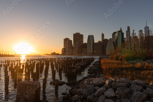 Beautiful New York City Sunset and Skyline along the East River seen From the Shore of Brooklyn Heights