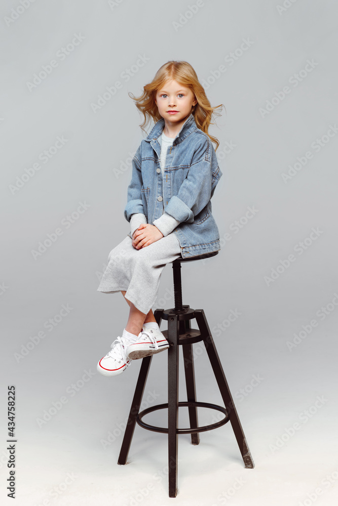 portrait of a little fashionable girl in the studio