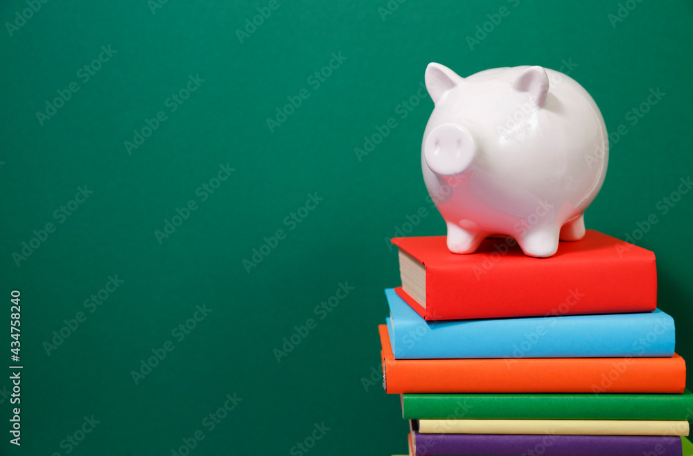 Composition with piggy bank and hardback books Composition with piggy bank and hardback books