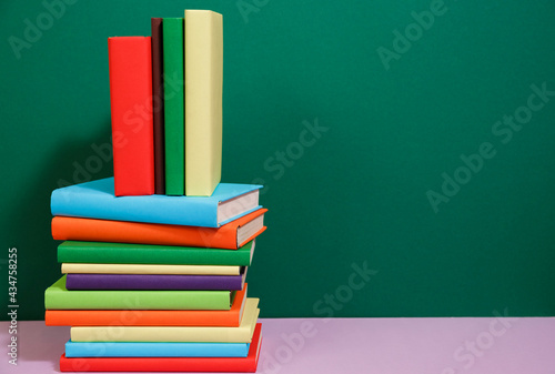 Composition with vintage old hardback books, colored background.