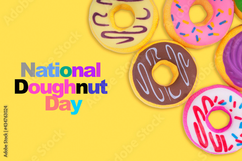 NATIONAL DOUGHNUT DAY text on yellow background. Doughnut Day Concept