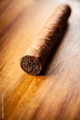 Brown cuban cigar on wooden background