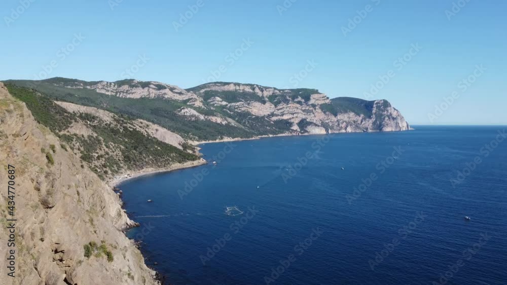 Image from a drone of beautiful seascape, with mountain peaks, rocks, ships floating in the open sea. High quality 4k footage Image from a drone of beautiful seascape, with mountain peaks, rocks, ships floating in the open sea. High quality 4k footage