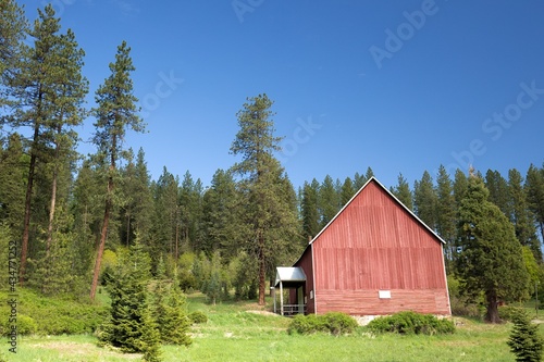 Red barn under a blue sky.