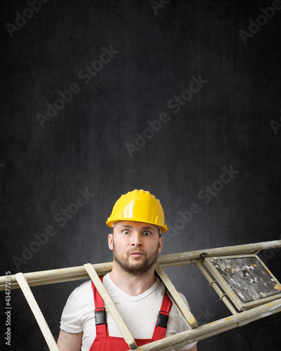 Portrait of a clumsy worker with ladder photo