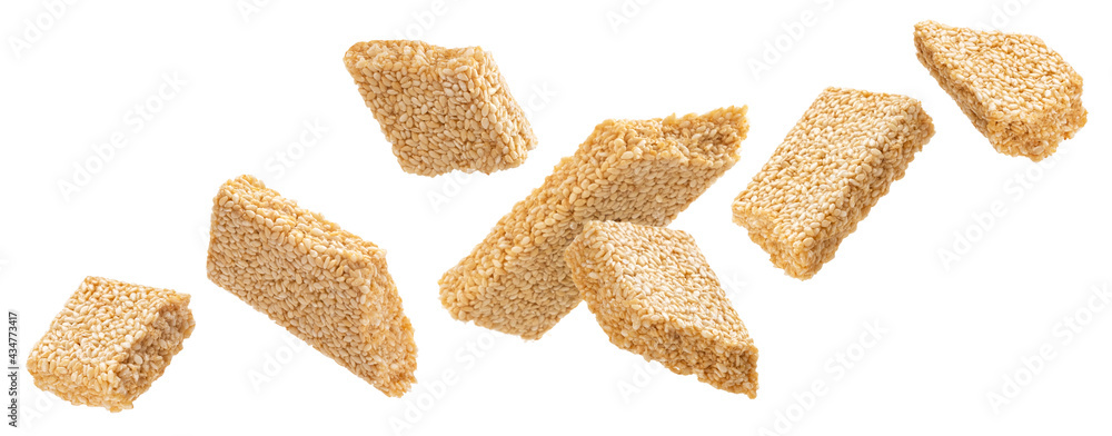 Falling sesame kozinaki isolated on white background Falling sesame kozinaki isolated on white background