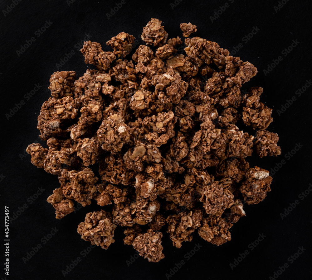 Chocolate granola on black background, top view Chocolate granola on black background, top view