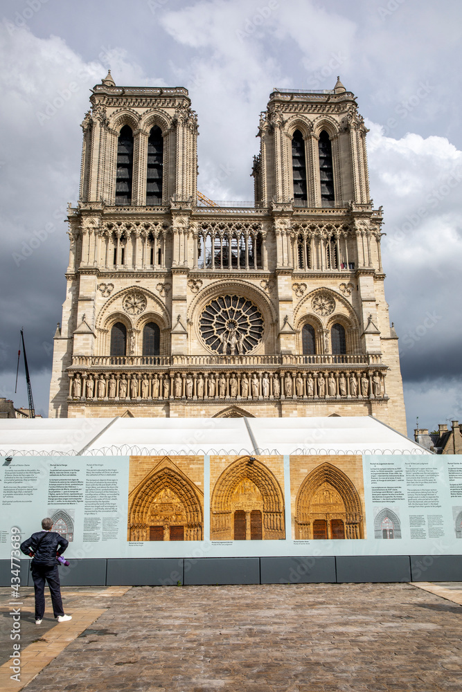 Notre Dame cathedral under repair, Paris, France. Pictures exhibited on the paved square.
