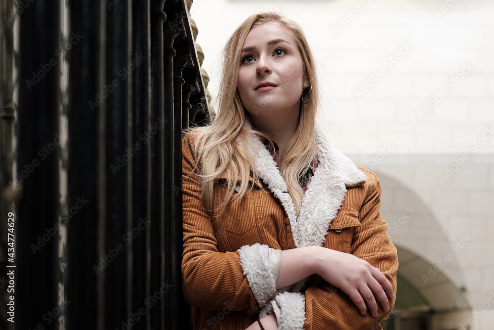 Fototapeta premium Young blonde woman posing in an urban environment.