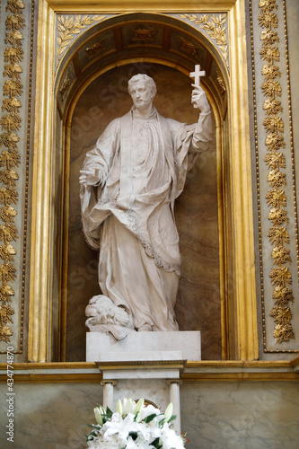 Saint Germain des Pres church, Paris, France. St Francois Xavier statue by Guillaume Coustou. The Jesuit missionary is depicted trampling paganism. photo