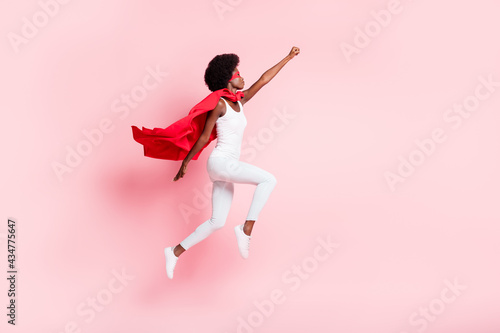 Full length body size view of active slim motivated wavy-haired girl jumping striving isolated on pink pastel color background