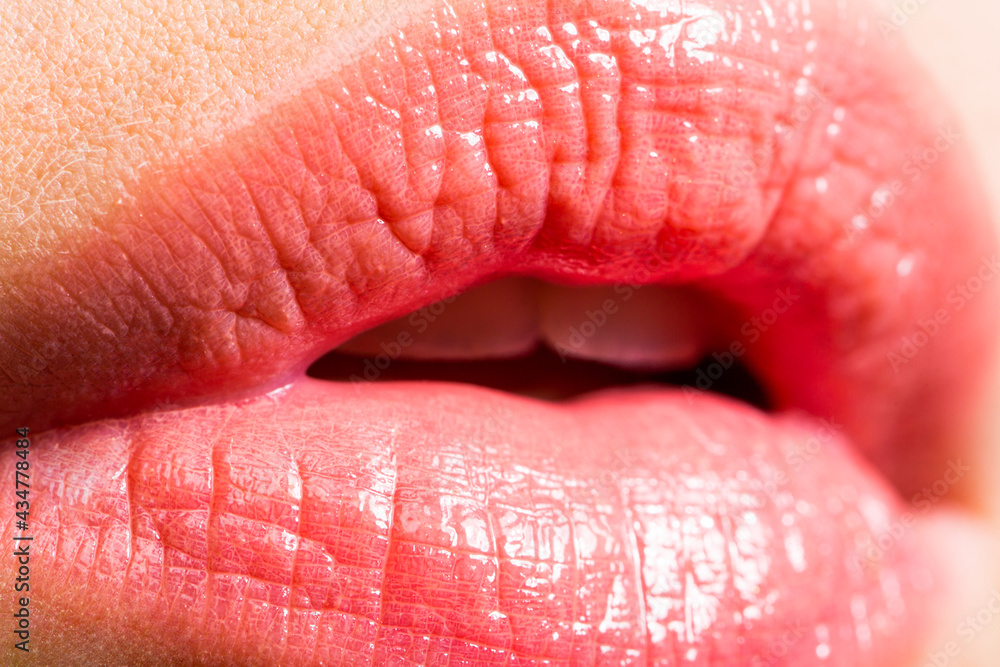 Fototapeta premium Plump sexy full lips. Pink lipstick. Perfect natural lip makeup. Close-up beautiful lips. Sexy plump lips nude lipstick. Close-up perfect natural lip makeup beautiful female mouth.