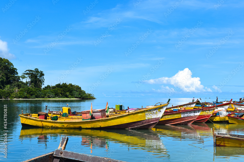 Wide shot of colorful fishing boats docked at the river mouth. Punts parked at the riverside.
