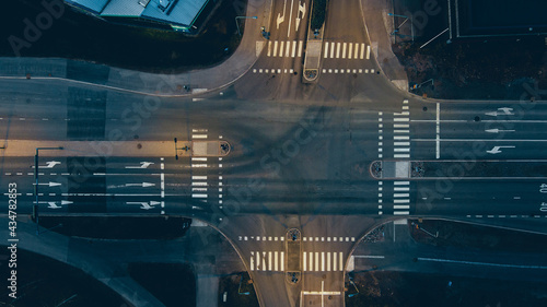 Aerial view of a junction with road markings at night.
