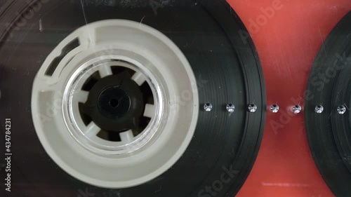 Audio cassette tape in use sound recording in the tape recorder. Vintage music cassette with a blank white , playing back in the player.	