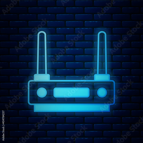Glowing neon Router and wi-fi signal icon isolated on brick wall background. Wireless ethernet modem router. Computer technology internet. Vector
