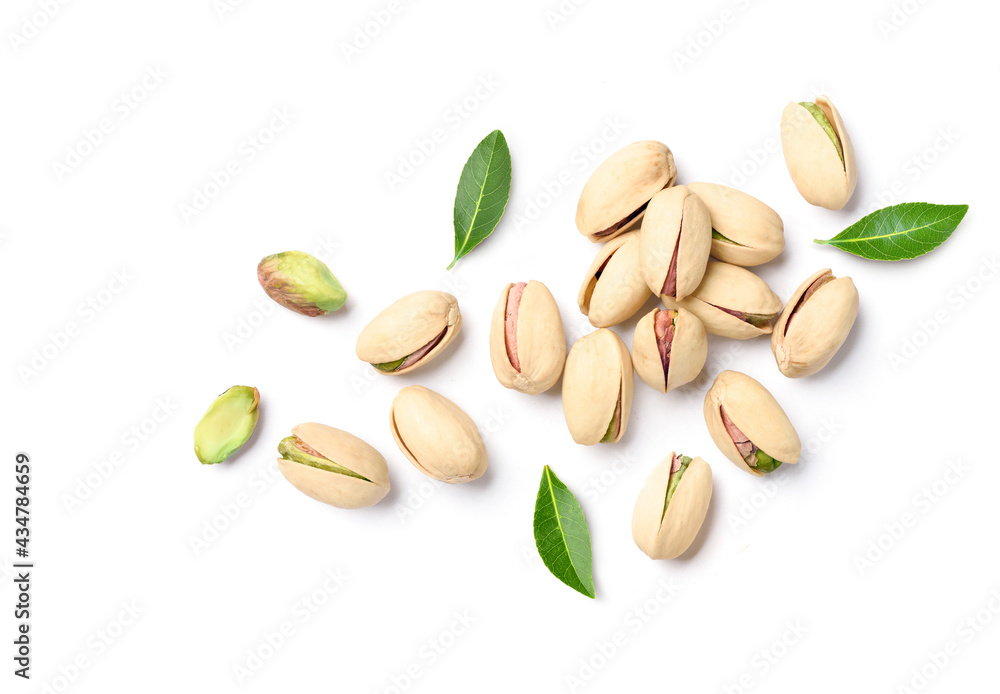 Flat lay of pistachio nuts with leaves on a white background. Flat lay of pistachio nuts with leaves on a white background.