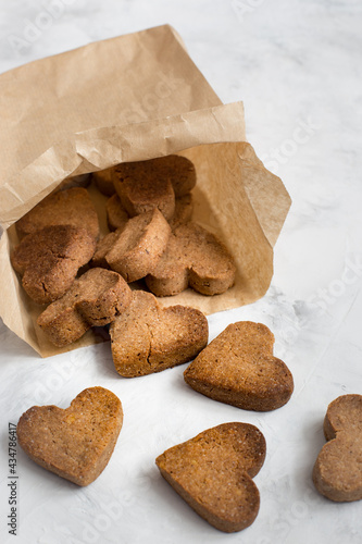 homemade heart-shaped cookies in a craft bag, a Valentine's Day gift with love, gluten-free buckwheat flour pastries.
