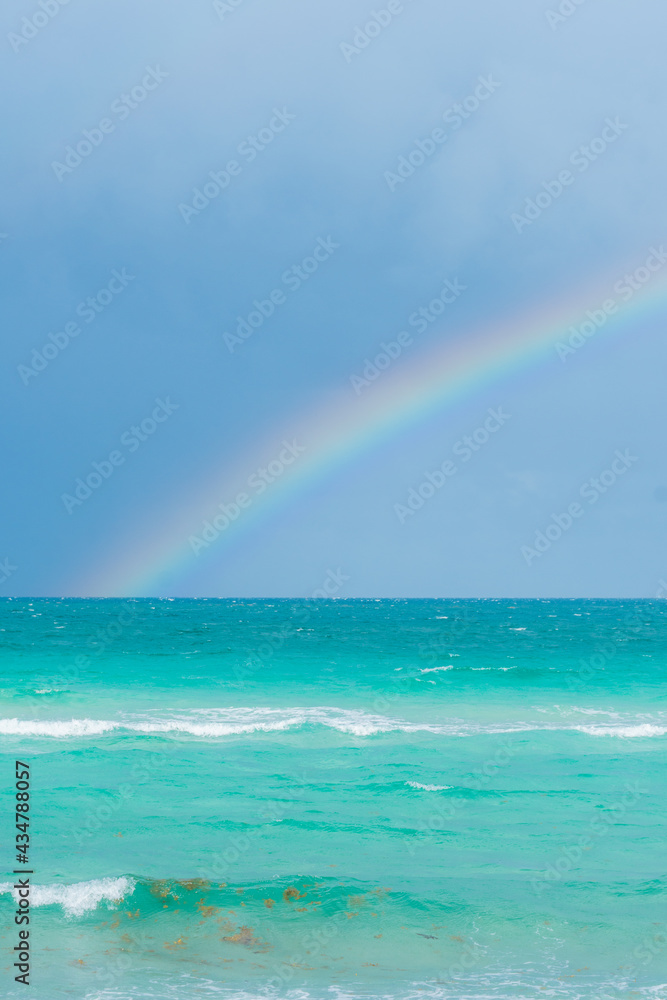 Rainbow on a cloudy day at the beach Rainbow on a cloudy day at the beach