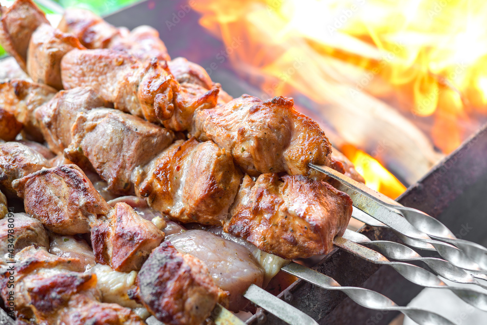Skewers of pork. Fried pork meat cooked over burning coals.