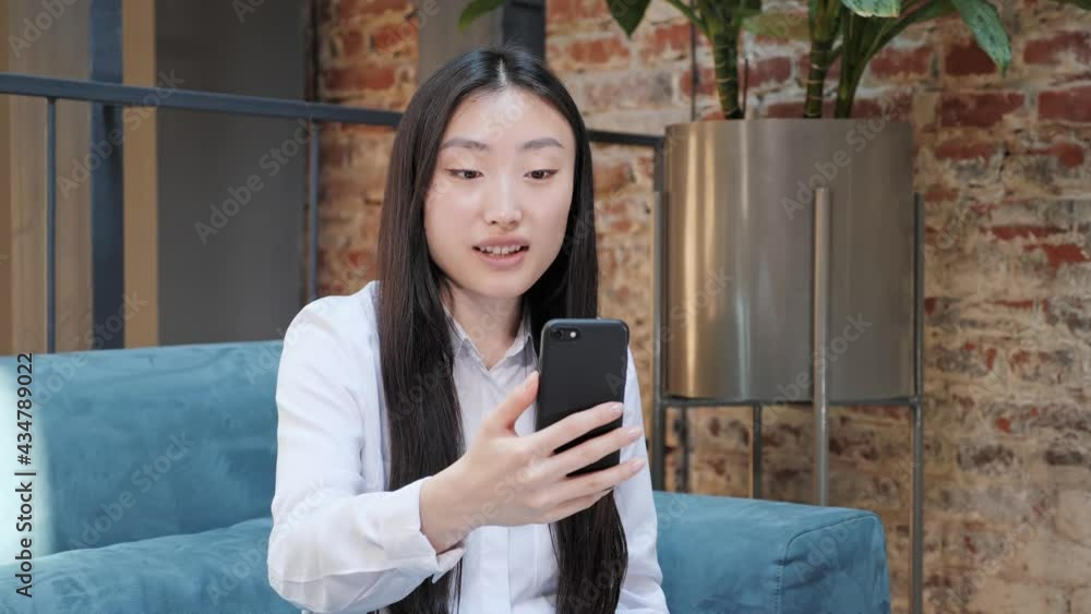 Beautiful business asian brunette japanese korean girl having video call using smartphone ethnic businesswoman speaking looking at screen computer, online conference distance office chat. Beautiful business asian brunette japanese korean girl having video call using smartphone ethnic businesswoman speaking looking at screen computer, online conference distance office chat.