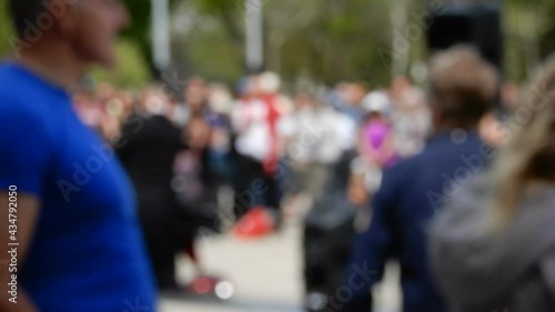 Wallpaper Mural People Standing Around At Protest Listening To Speaker As Muscular Man In Blue Shirt Walks Into Front Frame Torontodigital.ca