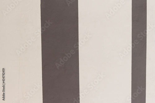 Brown and beige color stripes on a wall background