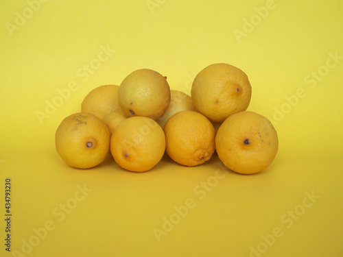 lemon fruits over yellow background