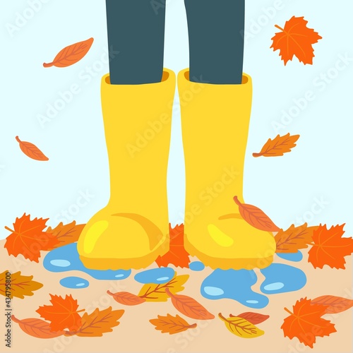 Legs in yellow rubber rain boots