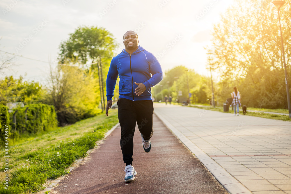 Sporty man jogging in a park stock photo