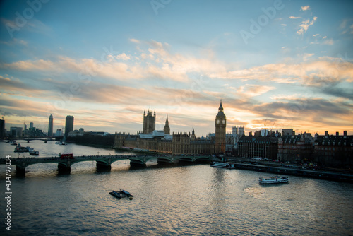 London  UK - February 4  2017  London skyline view at sunset with famous landmarks  Big Ben  Houses of Parliament and ships on River Thames with beautiful blue and yellow sky.
