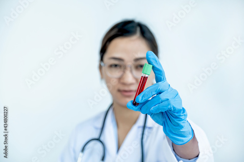 The doctor hand holding the blood tube of the patient  medical check-up concept