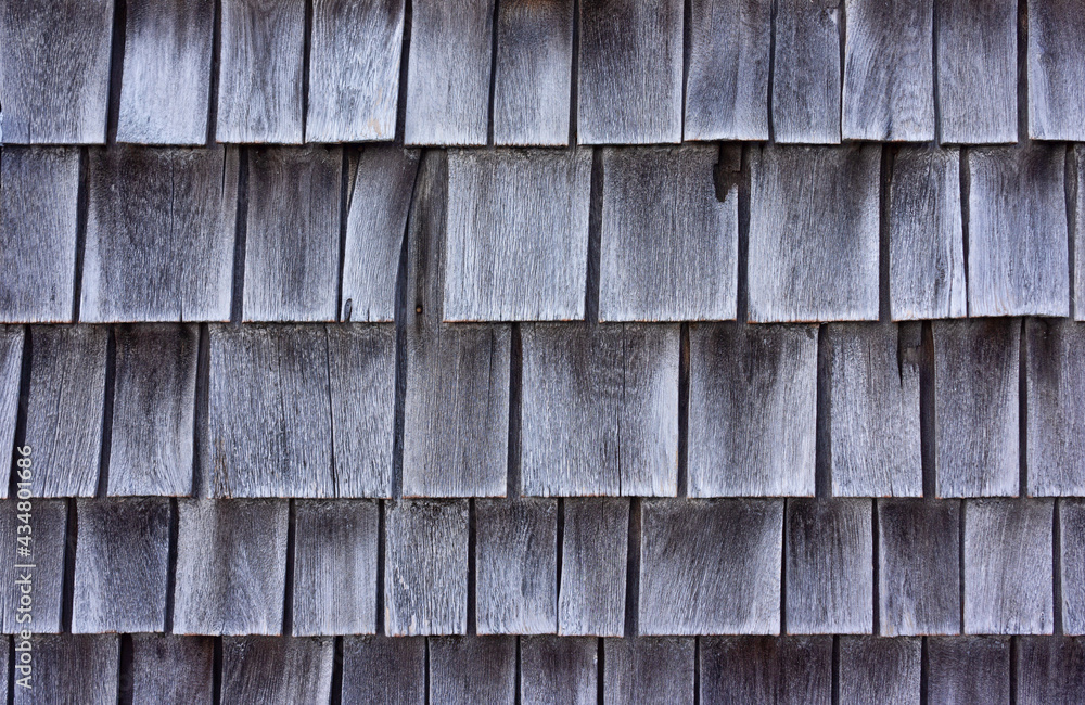 Cedar shingles which have shrunk and faded gray with age. Cedar shingles which have shrunk and faded gray with age.