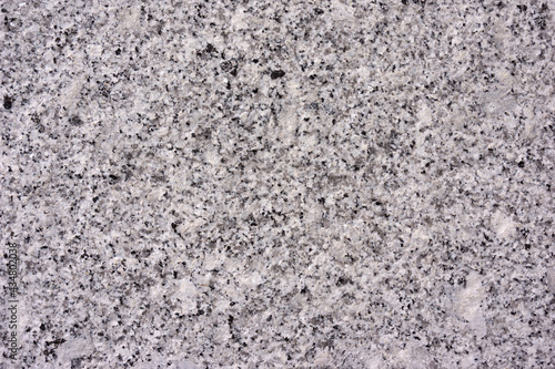 Close view of the smooth surface of a cut granite boulder.
